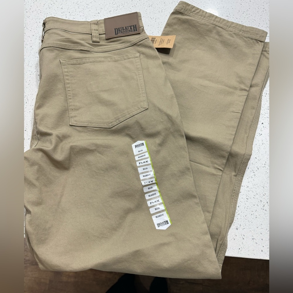 With tags, Duluth relaxed fit darker khaki men’s 36x34 pants.